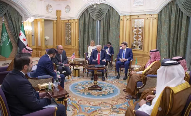 In this photo released by the Saudi Royal Palace, President Donald Trump, centre, and Secretary of State Marco Rubio , third from right, meet with Syria's interim President Ahmad al-Sharaa, second left, and with Saudi Crown Prince Mohammed bin Salman, second right, in Riyadh, Wednesday, May 14, 2025. (Bandar Aljaloud/Saudi Royal Palace via AP)