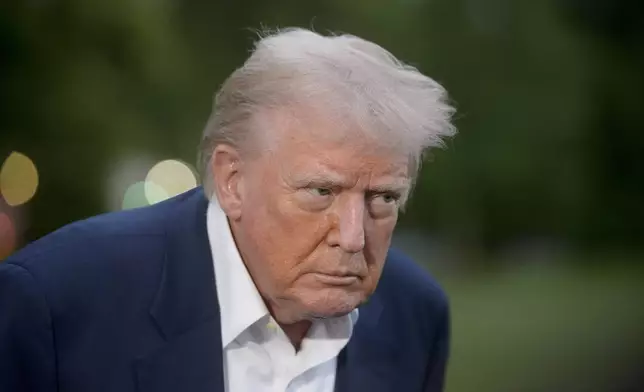 President Donald Trump speaks with reporters after disembarking Marine One upon arrival on the South Lawn of the White House in Washington, Sunday, May 4, 2025. (AP Photo/Rod Lamkey, Jr.)