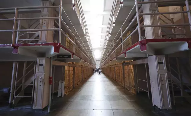 Visitors tour the prison cells on Alcatraz Island Monday, May 5, 2025, in San Francisco. (AP Photo/Jed Jacobsohn)