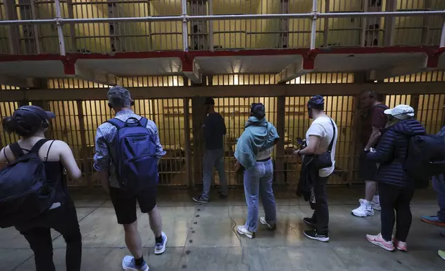 Visitors tour the prison cells on Alcatraz Island Monday, May 5, 2025, in San Francisco. (AP Photo/Jed Jacobsohn)