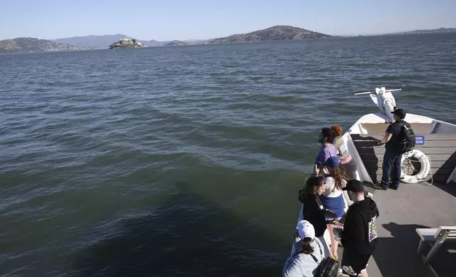 Visitors view Alcatraz Island from a tour boat Monday, May 5, 2025, in San Francisco. (AP Photo/Jed Jacobsohn)