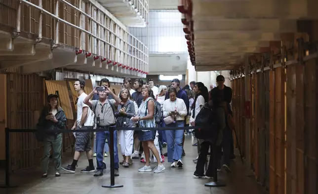Visitors tour the prison cells on Alcatraz Island Monday, May 5, 2025, in San Francisco. (AP Photo/Jed Jacobsohn)