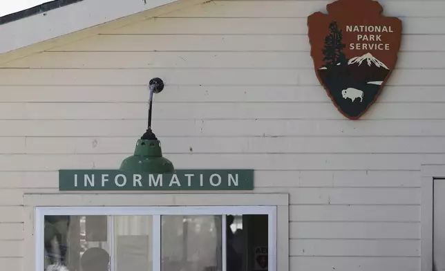 A National Park Service sign is shown above an Information booth during a tour of Alcatraz Island in San Francisco, Monday, May 5, 2025. (AP Photo/Jed Jacobsohn)