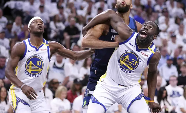 Golden State Warriors' Draymond Green and Jimmy Butler III vie for rebound position against Minnesota Timberwolves' Rudy Gobert in NBA Western Conference Semifinals' Game 5 at Target Center in Minneapolis on Wednesday, May 14, 2025. (Scott Strazzante/San Francisco Chronicle via AP)