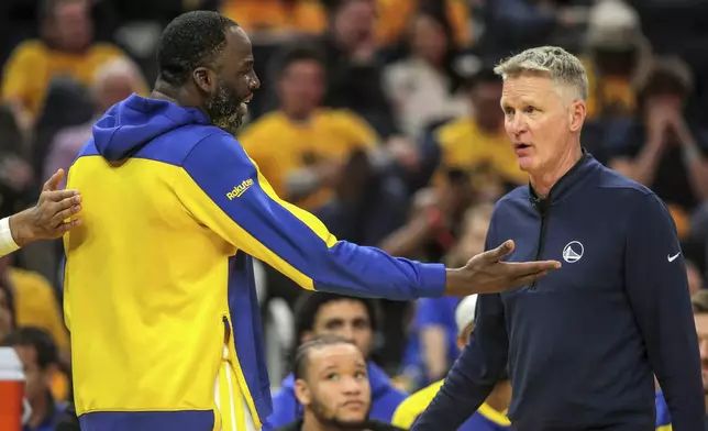 Golden State Warriors' Draymond Green (23) talks with head coach Steve Kerr after he fouled out during Game 3 of an NBA basketball second-round playoff series against the Minnesota Timberwolves in San Francisco, Saturday, May 10, 2025. (Carlos Avila Gonzalez/San Francisco Chronicle via AP)