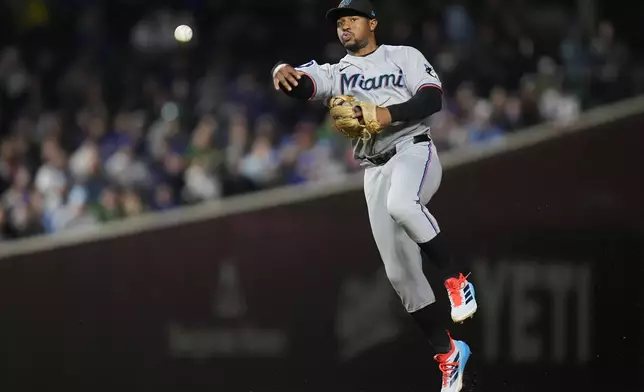 Miami Marlins shortstop Xavier Edwards (9) throws out Chicago Cubs' Kyle Tucker (30) during the eighth inning of a baseball game Tuesday, May 13, 2025, in Chicago. (AP Photo/Erin Hooley)