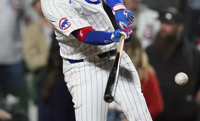 Chicago Cubs' Justin Turner (3) hits a walkoff double during the ninth inning to win a baseball game against the Miami Marlins, Tuesday, May 13, 2025, in Chicago. (AP Photo/Erin Hooley)