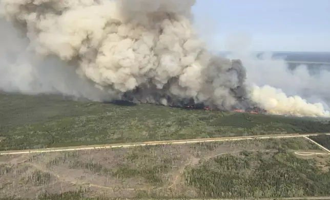 This photo provided by the Manitoba government shows wildfires in Wanless, Manitoba, Canada, on Tuesday, May 27, 2025. (Manitoba government via AP)