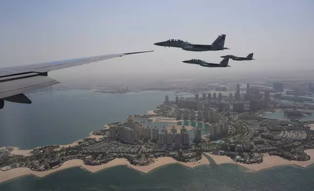 Qatar Emiri Air Force F-15s provide an honorary escort for Air Force One, carrying President Donald Trump, as it arrives in Doha, Qatar, Wednesday, May 14, 2025. (AP Photo/Alex Brandon)