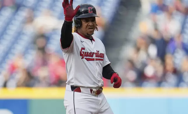 Cleveland Guardians' Jose Ramirez gestures from second base after hitting a double in the first inning of a baseball game against the Minnesota Twins in Cleveland, Wednesday, April 30, 2025. (AP Photo/Sue Ogrocki)