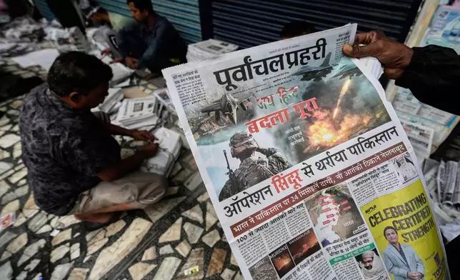 Vendors sort for distribution in Guwahati, India, news papers leading with reports of India firing missiles early Wednesday into Pakistani-controlled territory, Thursday, May 8, 2025. (AP Photo/Anupam Nath)