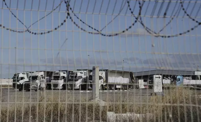 Trucks load with humanitarian aid for the Gaza Strip are seen at the Kerem Shalom Crossing in southern Israel, Tuesday May 20, 2025. (AP Photo/Maya Alleruzzo)
