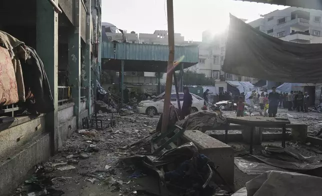 Palestinians inspect the damage at school used as a shelter by displaced residents that was hit by Israeli military strike and killed at least 36 people, in Gaza City, on Monday, May 26, 2025. (AP Photo/Jehad Alshrafi)