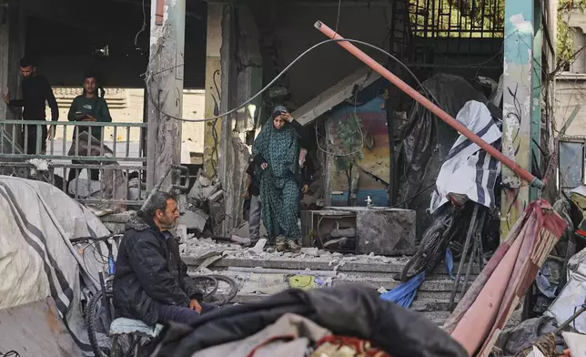 Palestinians inspect the damage at school used as a shelter by displaced residents that was hit by Israeli military strike and killed at least 36 people, in Gaza City, on Monday, May 26, 2025. (AP Photo/Jehad Alshrafi)