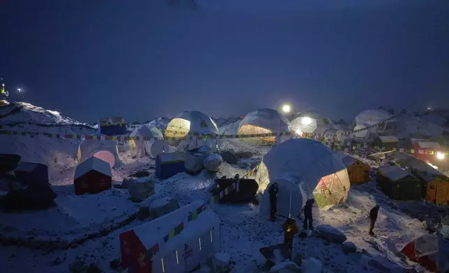 Members of an expedition to the summit of Mount Everest stand by their tents at the Everest Base Camp in Nepal, April 28, 2025. (AP Photo/Pasang Rinzee Sherpa)