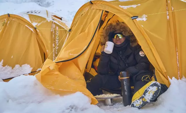 A climber rests early morning inside a tent at the Everest Base Camp in Nepal, Friday, May 2, 2025. (AP Photo/Pasang Rinzee Sherpa)