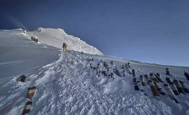 Oxygen cylinders are kept on a slope on the way to the summit of Mount Everest in Nepal, May 18, 2025. (AP Photo/Kunga Sherpa)