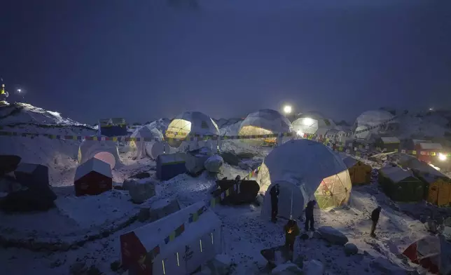 Members of an expedition to the summit of Mount Everest stand by their tents at the Everest Base Camp in Nepal, April 28, 2025. (AP Photo/Pasang Rinzee Sherpa)