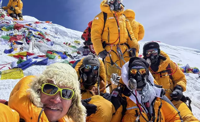 Mountaineers take a group selfie after summiting Mount Everest in Nepal, May 18, 2025. (AP Photo/Kunga Sherpa)