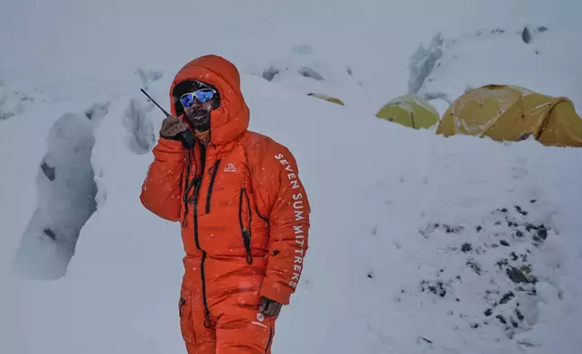 A mountain guide uses a radio at Camp 2 on the way to the summit of Mount Everest in Nepal, May 2, 2025. (AP Photo/Pasang Rinzee Sherpa)