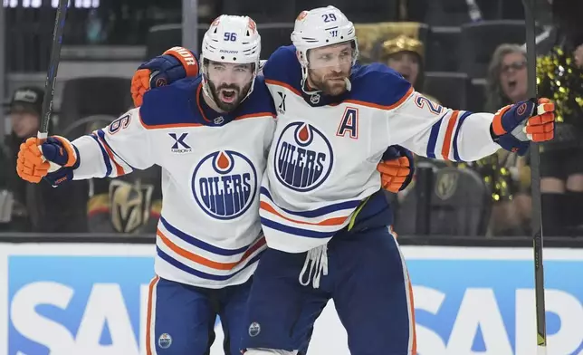 Edmonton Oilers center Leon Draisaitl (29) celebrates with teammates after scoring against the Vegas Golden Knights during the third period of Game 1 of a second-round NHL hockey playoff series Tuesday, May 6, 2025, in Las Vegas. (AP Photo/John Locher)