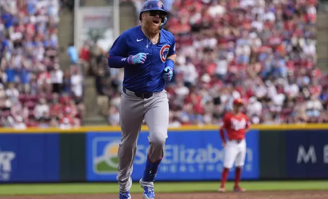 Chicago Cubs' Justin Turner round the bases after hitting a home run in the third inning of a baseball game against the Cincinnati Reds, Saturday, May 24, 2025, in Cincinnati. (AP Photo/Carolyn Kaster)