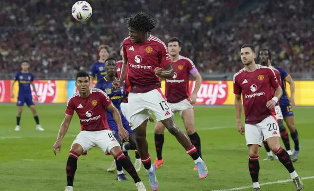 Manchester United's Patrick Dorgu, heads a ball during match withfights for the ball with ASEAN All-Star at the Challenge Cup Malaysia 2025 soccer tournament in Kuala Lumpur, Malaysia, Wednesday, May 28, 2025. (AP Photo/Vincent Thian)