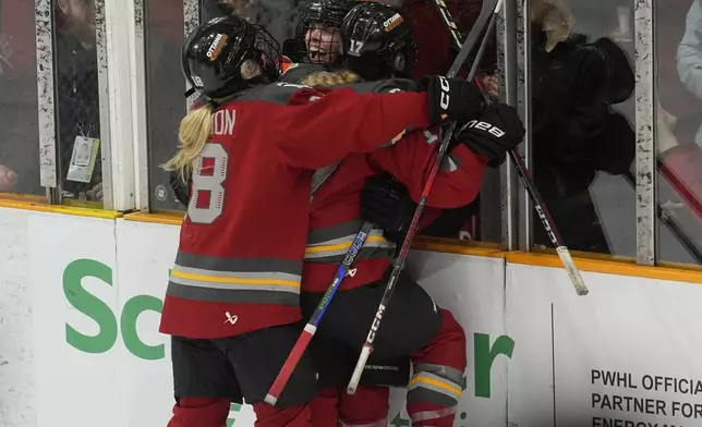 Ottawa Charge forward Emily Clark (26) celebrates her game winning overtime goal with teammates Mannon McMahon (18) and Gabbie Hughes (17) during overtime action against the Minnesota Frost in the PWHL final, Tuesday May 20, 2025 in Ottawa. (Adrian Wyld/The Canadian Press via AP)