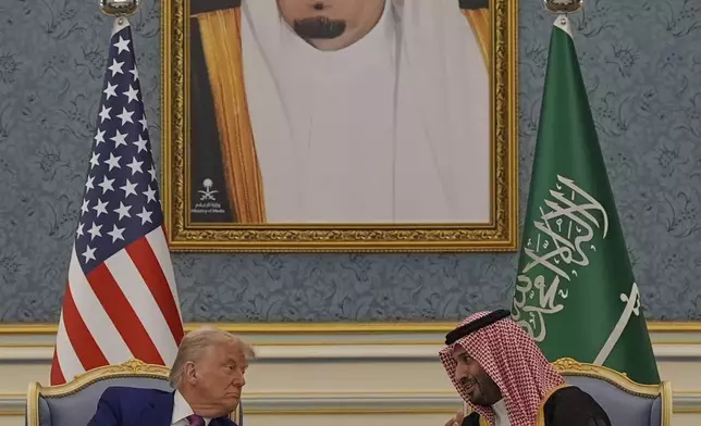 President Donald Trump and Saudi Crown Prince Mohammed bin Salman speak during a meeting at the Royal Palace in Riyadh, Saudi Arabia, Tuesday, May 13, 2025. (AP Photo/Alex Brandon)