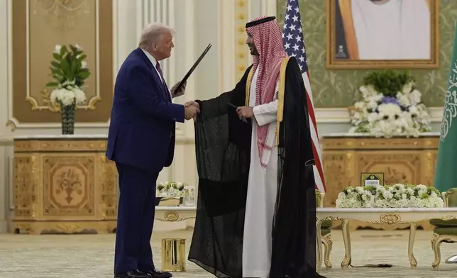 President Donald Trump and Saudi Crown Prince Mohammed bin Salman shake hands after exchanging documents during a signing ceremony at the Royal Palace in Riyadh, Saudi Arabia, Tuesday, May 13, 2025. (AP Photo/Alex Brandon)