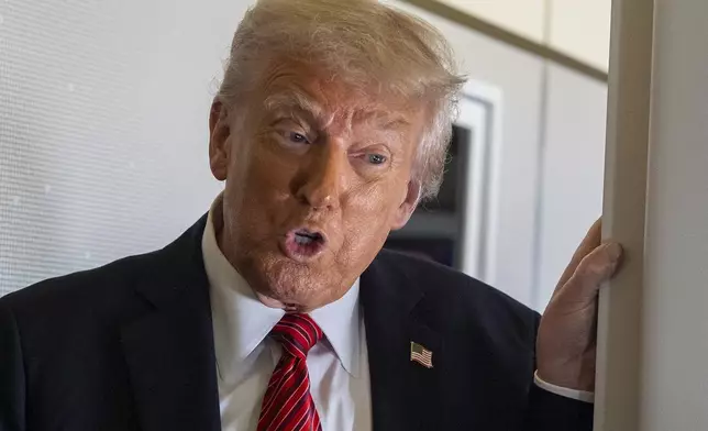 President Donald Trump speaks to reporters aboard Air Force One en route from Riyadh, Saudi Arabia to Doha, Qatar, Wednesday, May 14, 2025. (AP Photo/Alex Brandon)