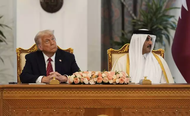 President Donald Trump and Qatar's Emir Sheikh Tamim bin Hamad Al Thani attend a signing ceremony at the Amiri Diwan in Doha, Qatar, Wednesday, May 14, 2025. (AP Photo/Alex Brandon)