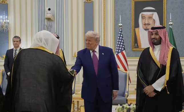 President Donald Trump and Saudi Crown Prince Mohammed bin Salman greet delegations during an arrival ceremony at the Royal Palace in Riyadh, Saudi Arabia, Tuesday, May 13, 2025. (AP Photo/Alex Brandon)