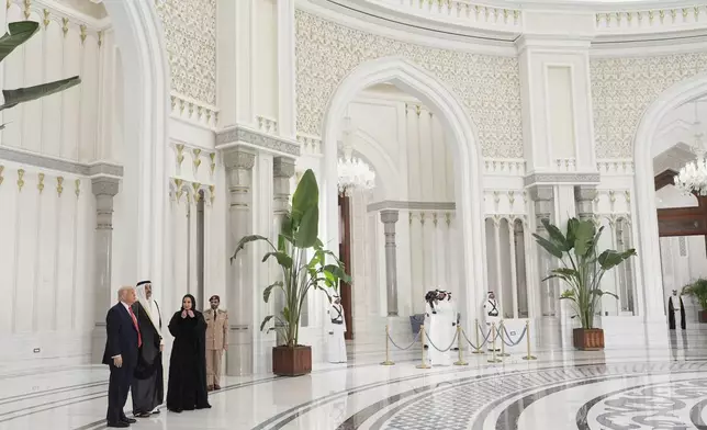President Donald Trump speaks with Qatar's Emir Sheikh Tamim bin Hamad Al Thani prior a state dinner at the Lusail Palace, in Doha, Qatar, Wednesday, May 14, 2025. (AP Photo/Alex Brandon)
