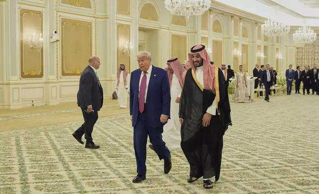 President Donald Trump and Saudi Crown Prince Mohammed bin Salman walk for a signing ceremony at the Royal Palace in Riyadh, Saudi Arabia, Tuesday, May 13, 2025. (AP Photo/Alex Brandon)