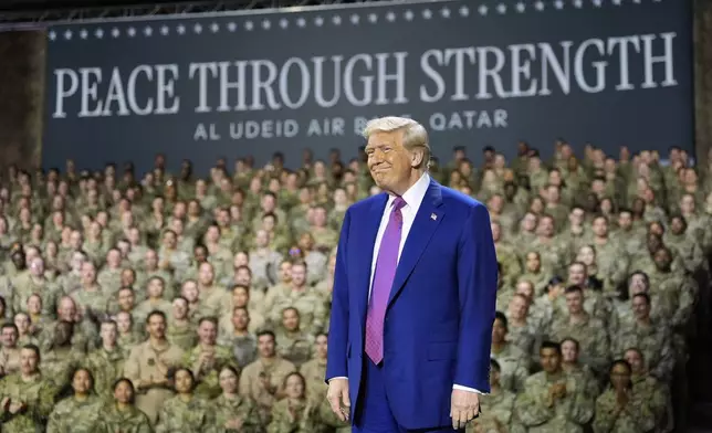 President Donald Trump smiles on stage at the Al Udeid Air Base, Thursday, May 15, 2025, in Doha, Qatar. (AP Photo/Alex Brandon)