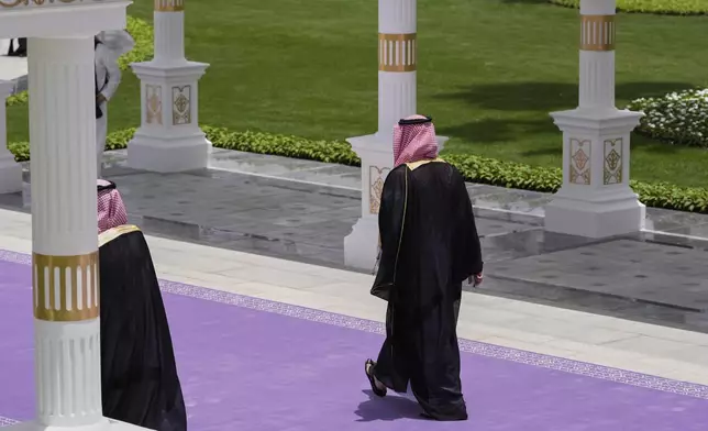 Saudi Crown Prince Mohammed bin Salman walks along a purple carpet during a welcome ceremony for President Donald Trump at the Royal Palace in Riyadh, Saudi Arabia, Tuesday, May 13, 2025. (AP Photo/Alex Brandon)