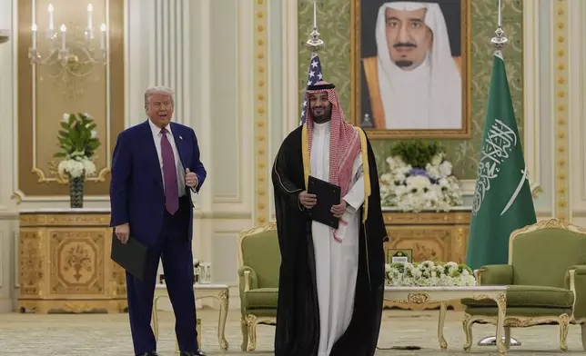 President Donald Trump and Saudi Crown Prince Mohammed bin Salman pose for a photo after exchanging documents during a signing ceremony at the Royal Palace in Riyadh, Saudi Arabia, Tuesday, May 13, 2025. (AP Photo/Alex Brandon)