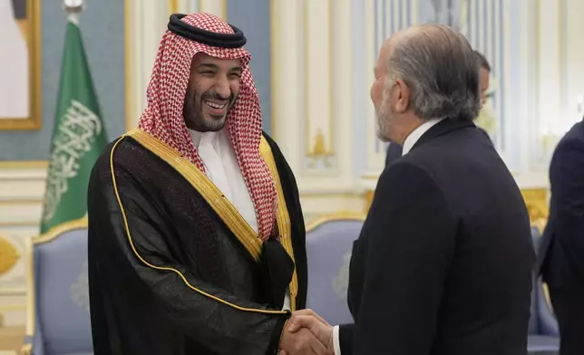 Saudi Crown Prince Mohammed bin Salman greets Commerce Secretary Howard Lutnick at the Royal Palace in Riyadh, Saudi Arabia, Tuesday, May 13, 2025. (AP Photo/Alex Brandon)