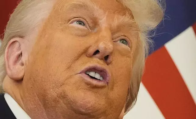 President Donald Trump gestures as meets Qatar's Emir Sheikh Tamim bin Hamad Al Thani at the Amiri Diwan in Doha, Qatar, Wednesday, May 14, 2025. (AP Photo/Alex Brandon)