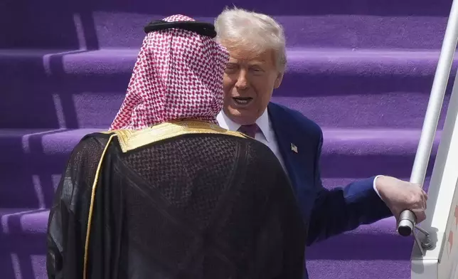 President Donald Trump speaks with Saudi Crown Prince Mohammed bin Salman during an arrival ceremony at the Royal Terminal of King Khalid International Airport in Riyadh, Saudi Arabia, Tuesday, May 13, 2025. (AP Photo/Alex Brandon)