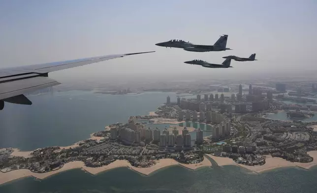 Qatar Emiri Air Force F-15s provide an honorary escort for Air Force One, carrying President Donald Trump, as it arrives in Doha, Qatar, Wednesday, May 14, 2025. (AP Photo/Alex Brandon)