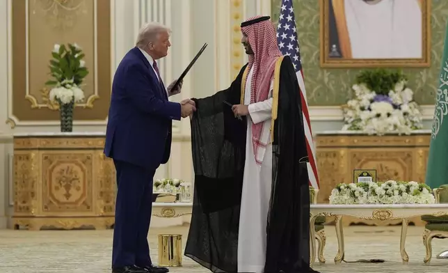 President Donald Trump and Saudi Crown Prince Mohammed bin Salman shake hands after exchanging documents during a signing ceremony at the Royal Palace in Riyadh, Saudi Arabia, Tuesday, May 13, 2025. (AP Photo/Alex Brandon)