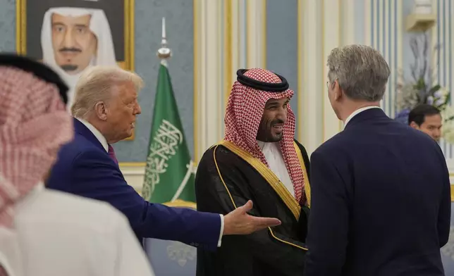 President Donald Trump and Saudi Crown Prince Mohammed bin Salman greet Treasury Secretary Scott Bessen at the Royal Palace in Riyadh, Saudi Arabia, Tuesday, May 13, 2025. (AP Photo/Alex Brandon)