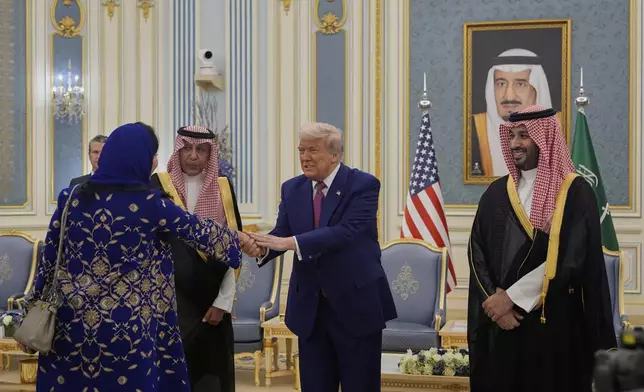 President Donald Trump greets Reema bint Bandar Al Saud, Saudi ambassador to the United States, at the Royal Palace in Riyadh, Saudi Arabia, Tuesday, May 13, 2025 (AP Photo/Alex Brandon)