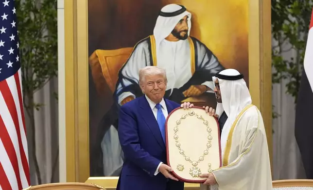 President Donald Trump is presented the Order of Zayed, the UAE highest civilian distinction, from UAE President Mohammed bin Zayed Al Nahyan at Qasr Al Watan, Thursday, May 15, 2025, in Abu Dhabi, United Arab Emirates. (AP Photo/Alex Brandon)