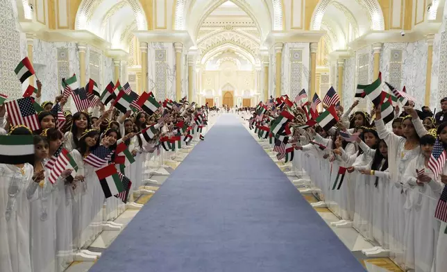 Children prepare to greet President Donald Trump and UAE President Mohammed bin Zayed Al Nahyan as they for a State Dinner at Qasr Al Watan, Thursday, May 15, 2025, in Abu Dhabi, United Arab Emirates. (AP Photo/Alex Brandon)