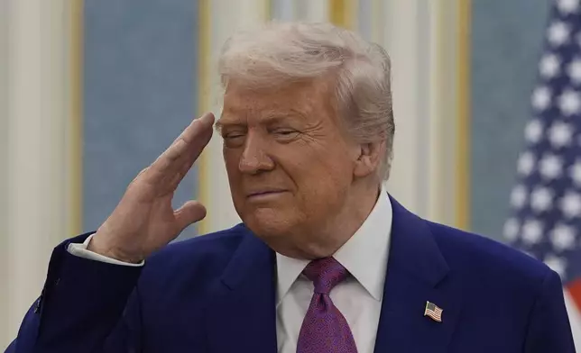 President Donald Trump salutes as he greets with Saudi Crown Prince Mohammed bin Salman delegations at the Royal Palace in Riyadh, Saudi Arabia, Tuesday, May 13, 2025. (AP Photo/Alex Brandon)