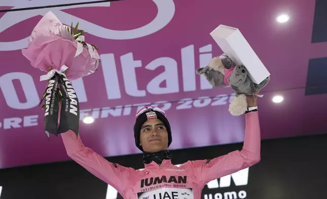 Mexico's Isaac Del Toro wears the pink jersey of the race overall leader as he celebrates on the podium after completing the 12th stage of the Giro d'Italia cycling race from Modena to Viadana (Oglio-Po), Italy, Thursday, May 22, 2025. (Fabio Ferrari/LaPresse via AP)