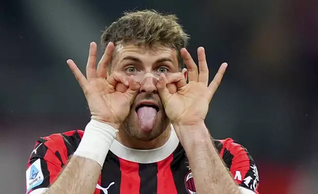 AC Milan's Santiago Gimenez celebrates after scoring their first goal during the Serie A soccer match between Milan and Bologna at San Siro Stadium in Milan, Italy, Friday May 9, 2025. (Spada/LaPresse via AP)